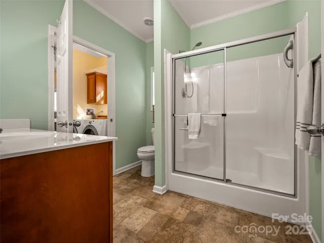 a bathroom with a shower sink and toilet