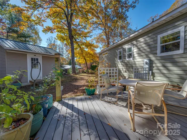 a view of backyard with outdoor seating and wooden floor