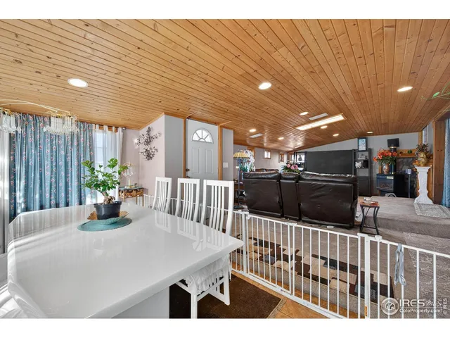 a dining room with furniture and a flat screen tv