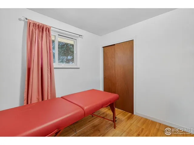 a bedroom with a bed and a chair