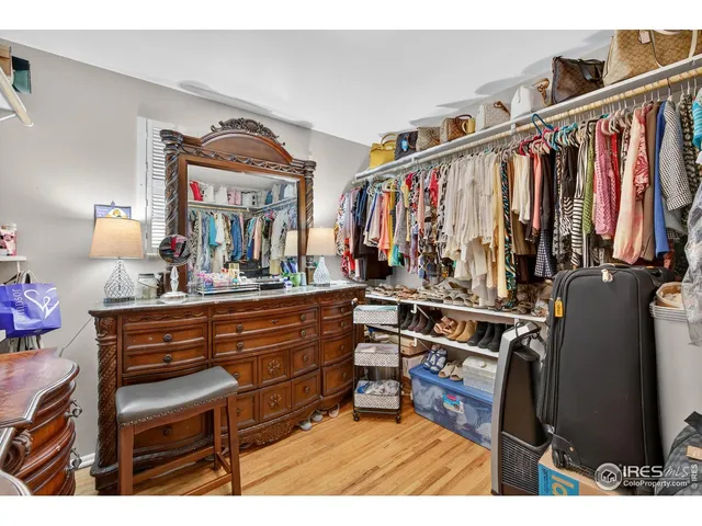 a view of walk in closet with clothes and shoes