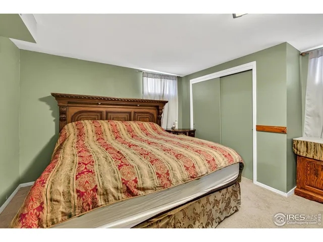 a bedroom with a bed and a mirror