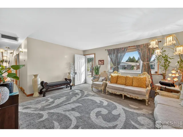 a spacious bedroom with a bed a couch and large window