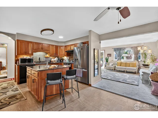 a kitchen with stainless steel appliances granite countertop a refrigerator and a stove top oven