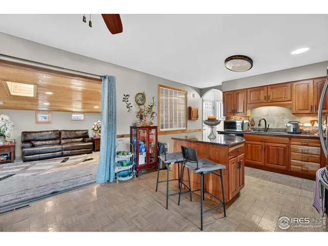 a kitchen with stainless steel appliances kitchen island granite countertop a table and chairs