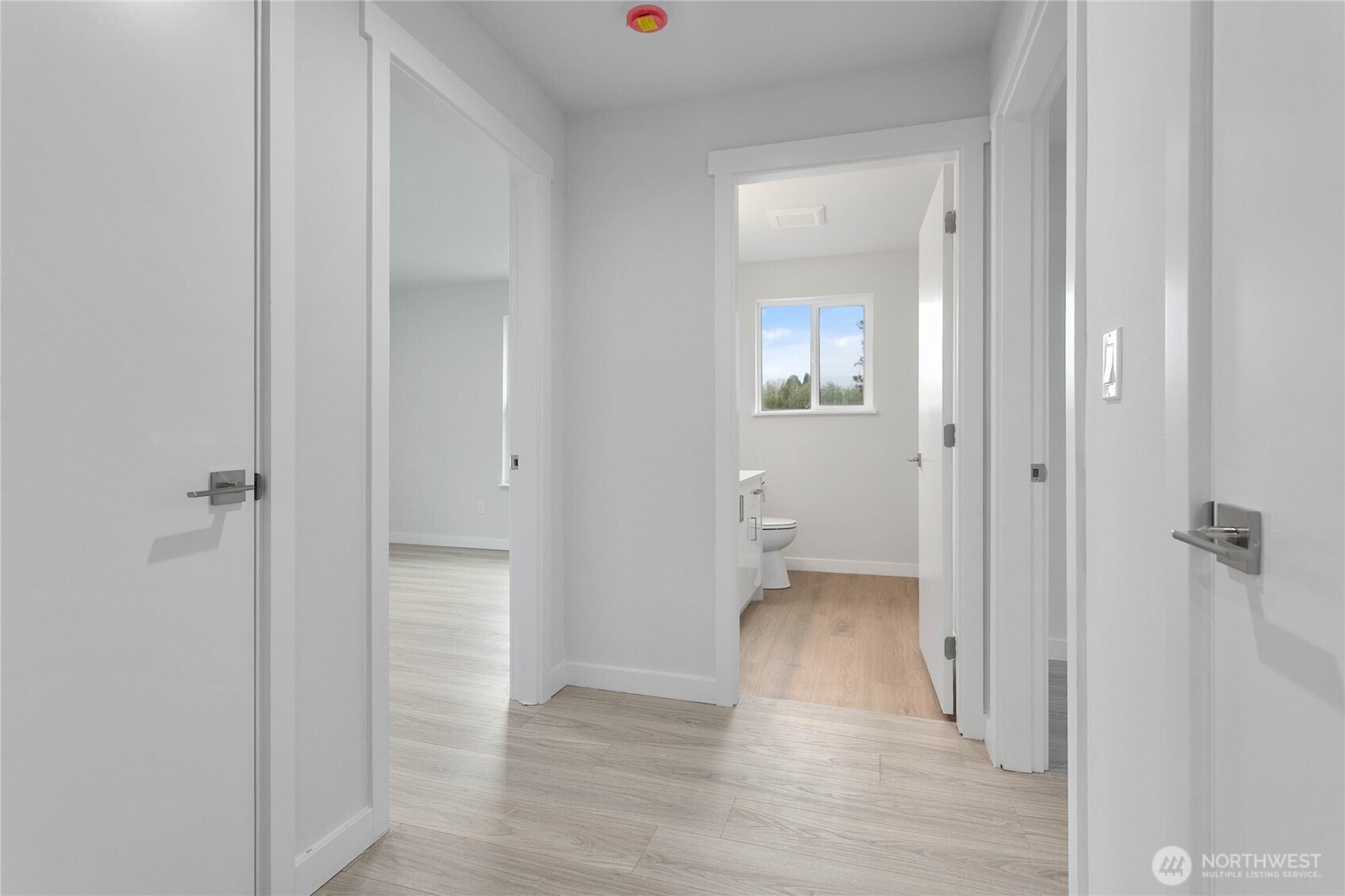4656 Bay Road Blaine, WA 98230 - Photo 12 of 31 a view of a hallway with wooden floor and a bathroom