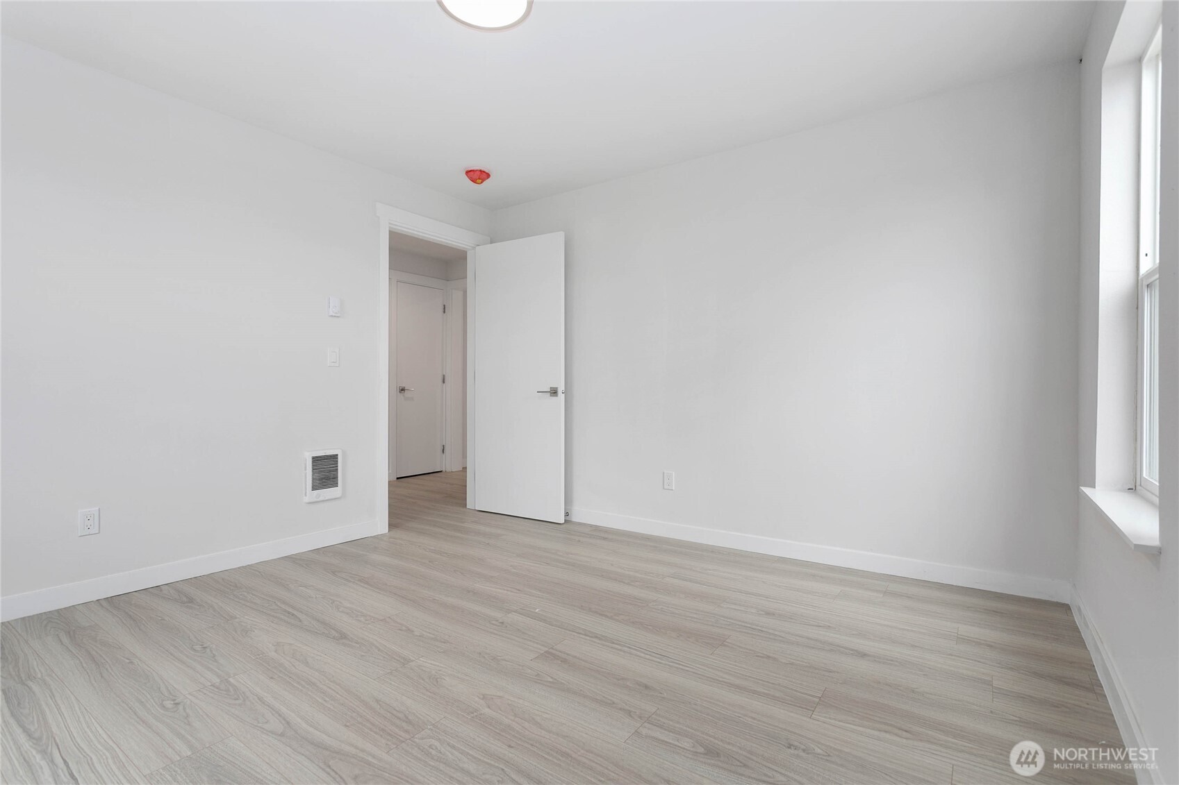 4656 Bay Road Blaine, WA 98230 - Photo 14 of 31 an empty room with wooden floor and windows