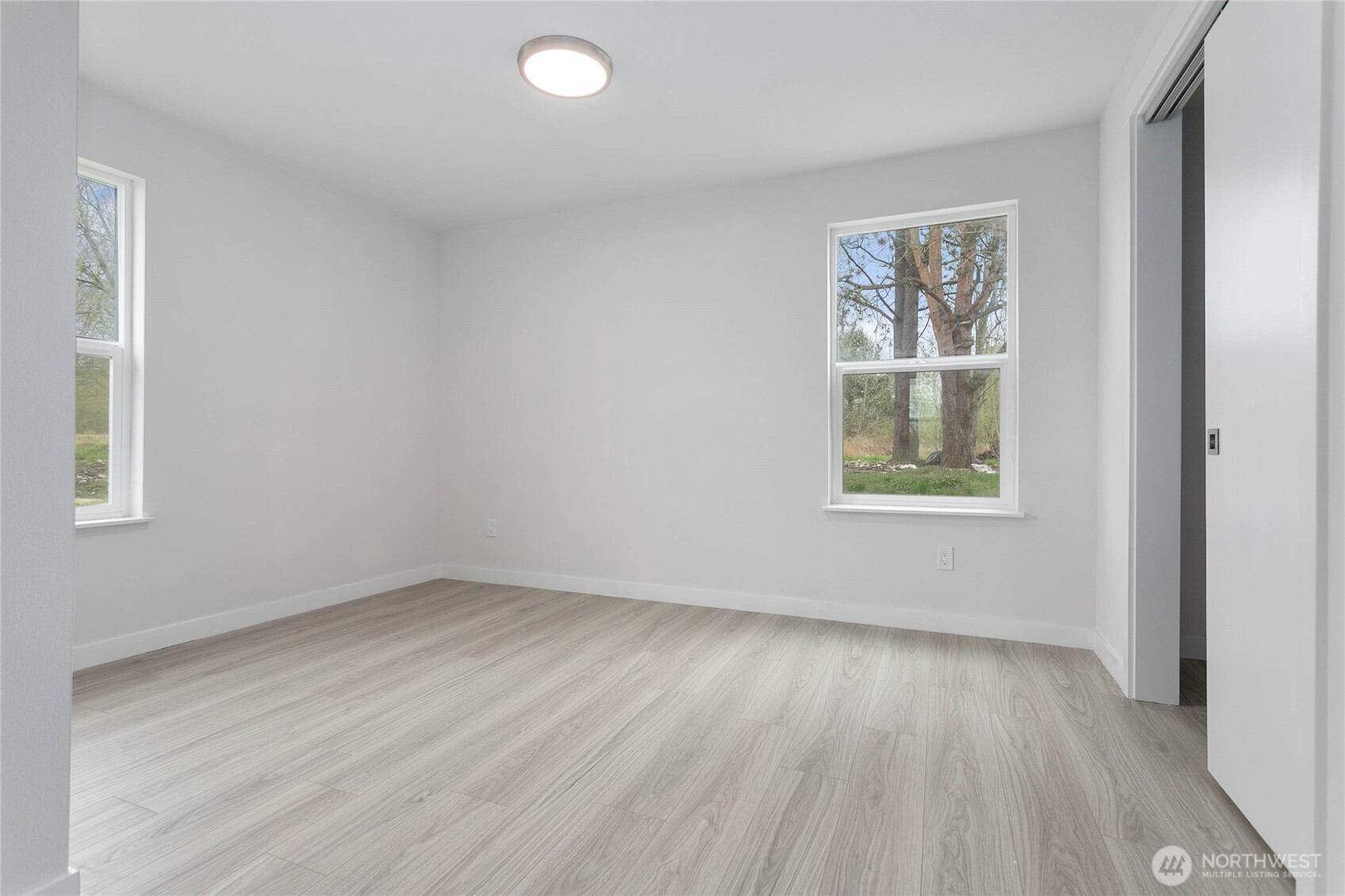 4656 Bay Road Blaine, WA 98230 - Photo 16 of 31 an empty room with wooden floor and windows