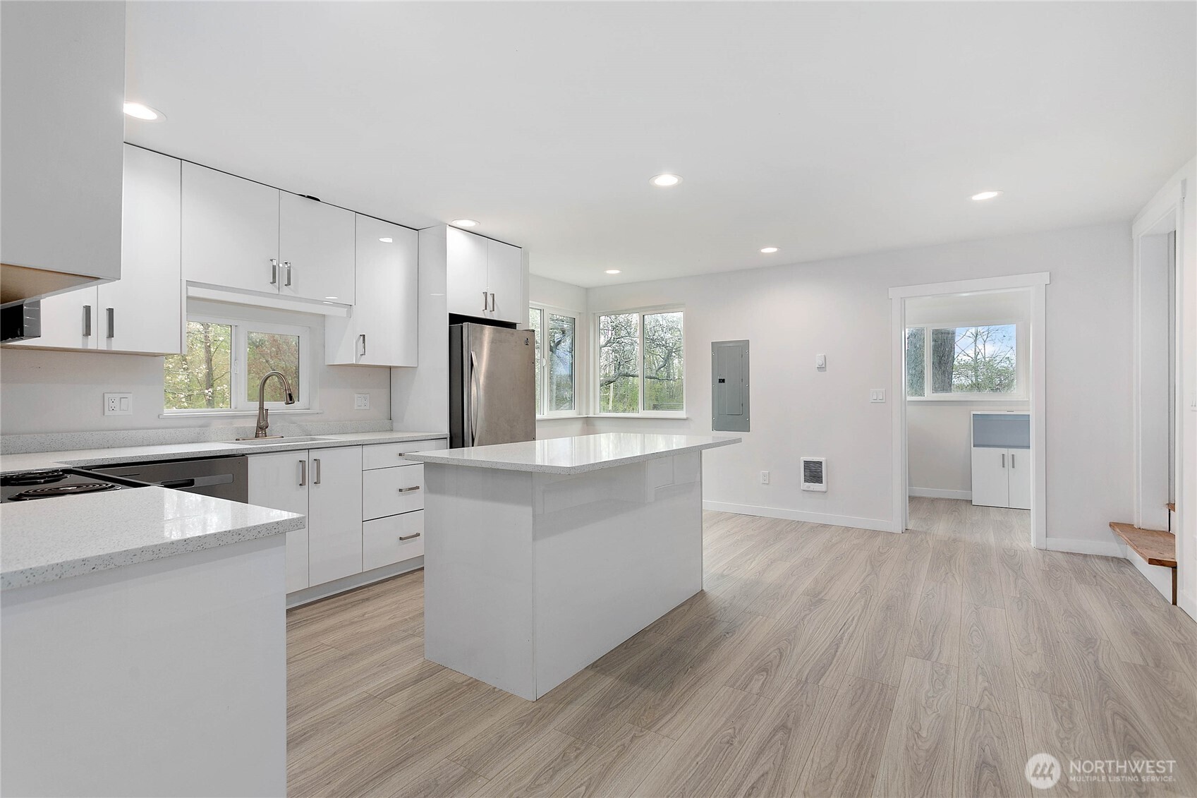 4656 Bay Road Blaine, WA 98230 - Photo 3 of 31 a large kitchen with cabinets wooden floor and stainless steel appliances