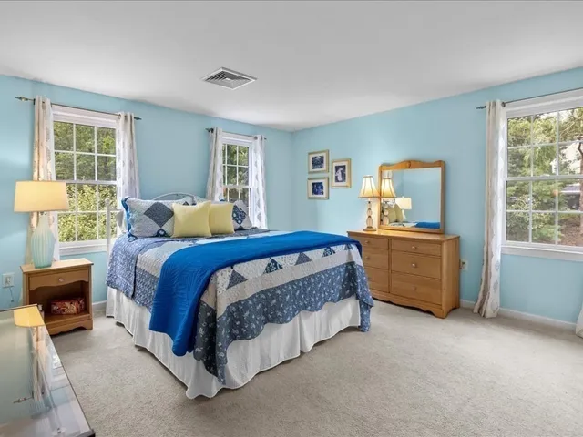 a bedroom with a bed and a table