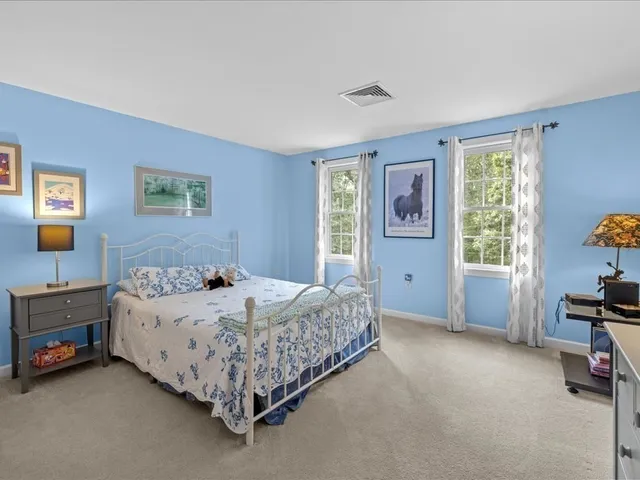 a bed sitting in a bedroom next to a window