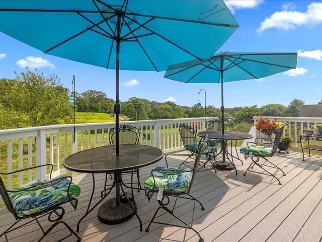 a view of a balcony with furniture and umbrella