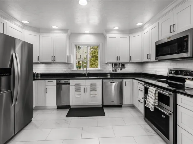a kitchen with a sink stove and microwave