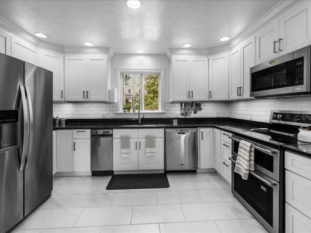 6 Wood Street Upton, MA 01568 - Photo 10 of 40 a kitchen with a sink stove and microwave
