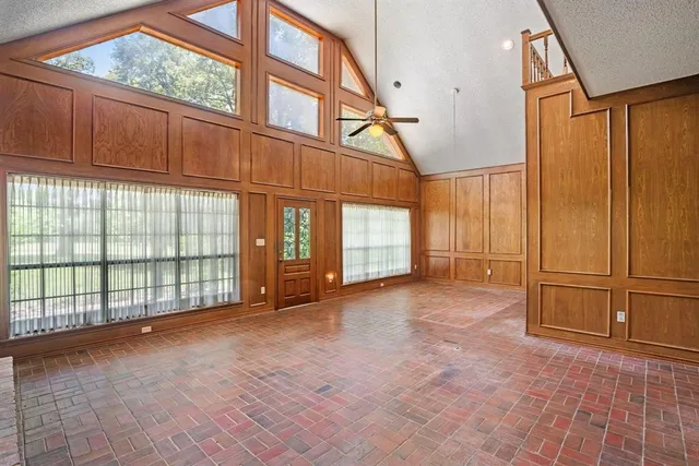 a bathroom with a granite countertop toilet sink and mirror