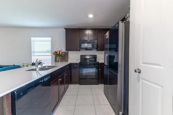 a kitchen with a sink and refrigerator