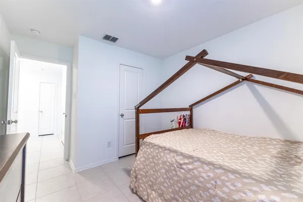 a bedroom with a bed and a dresser