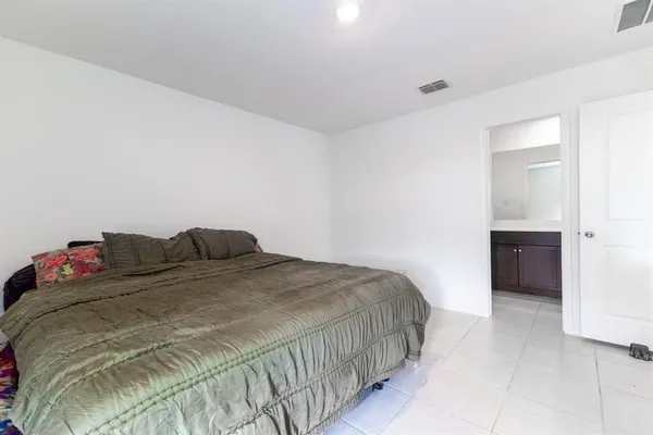 a bedroom with a bed and a table