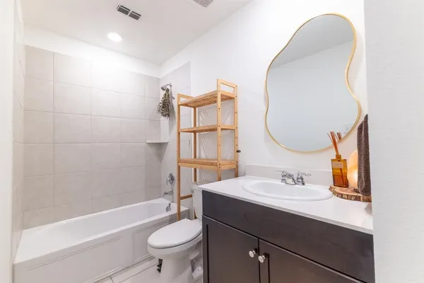 a bathroom with a sink a toilet and a mirror
