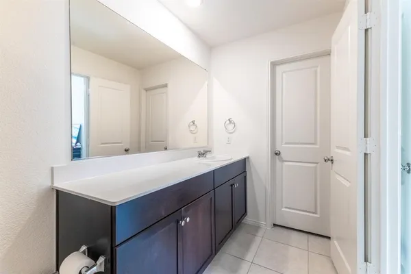 a room with a sink and a mirror