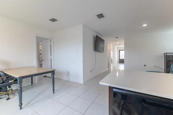 a view of a kitchen with a table and chairs