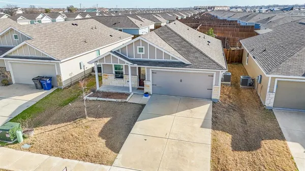 an aerial view of a house with a yard