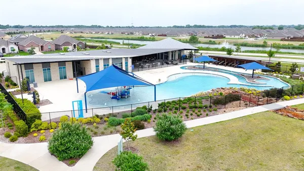 an aerial view of a house with outdoor space and lake view