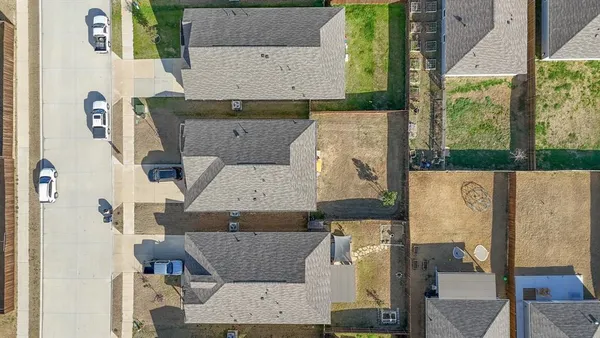 an aerial view of residential houses with outdoor space
