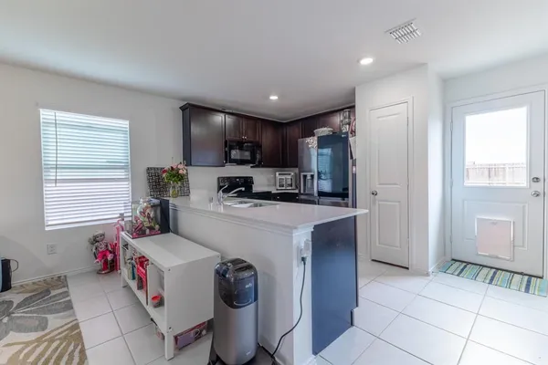 a kitchen that has a sink cabinets and window