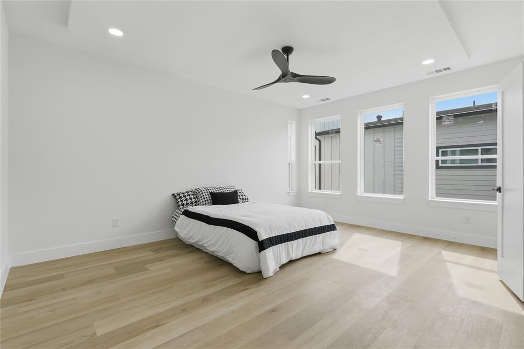 3905 Blue Ridge Boulevard Dallas, TX 75233 - Photo 14 of 25 Recessed lighting, wood-finish flooring, contemporary ceiling fan, multiple windows, and a tray ceiling