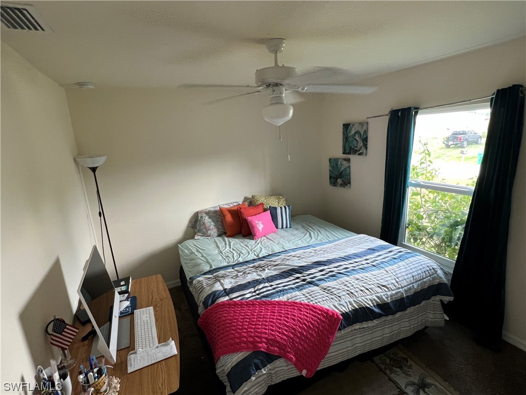 5018 Dolphin Circle LaBelle, FL 33935 - Photo 11 of 17 a bedroom with a bed and dresser