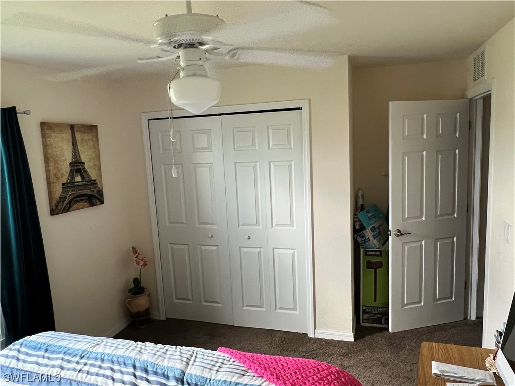 5018 Dolphin Circle LaBelle, FL 33935 - Photo 12 of 17 a bedroom with a bed and a chandelier