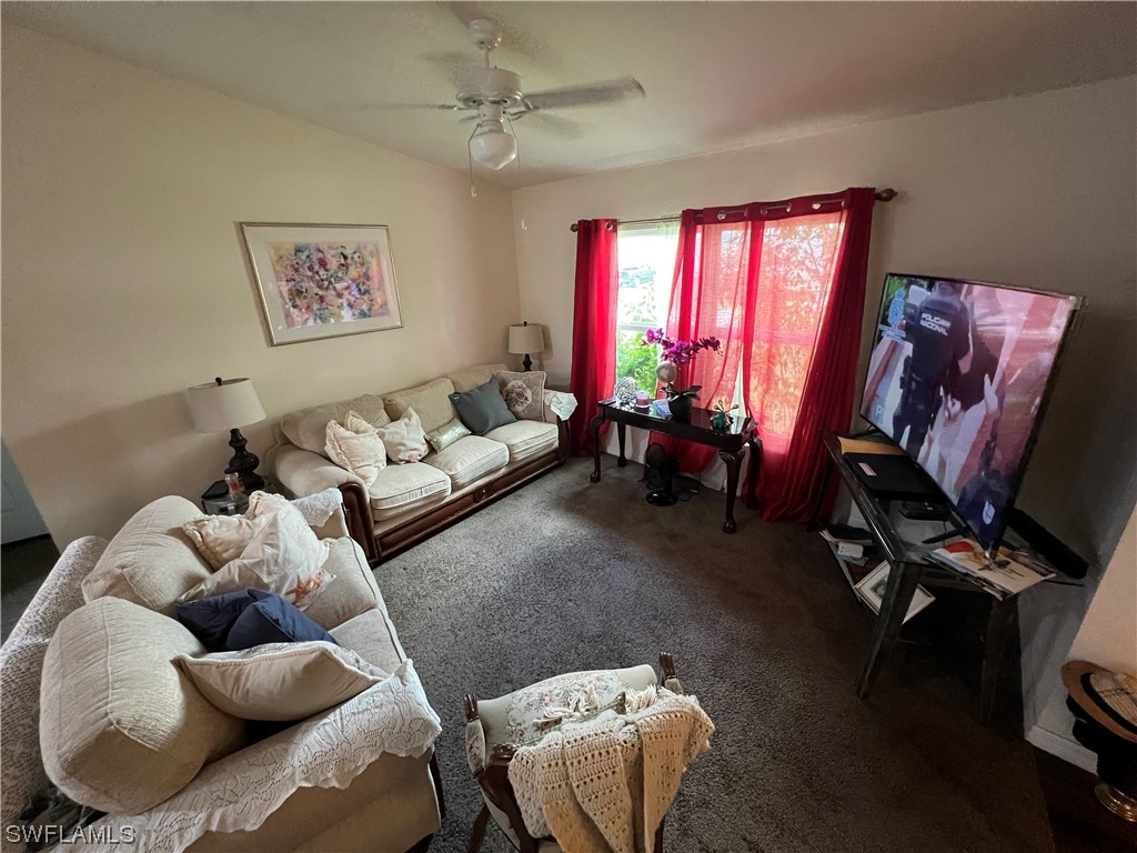 5018 Dolphin Circle LaBelle, FL 33935 - Photo 3 of 17 a living room with furniture and a flat screen tv