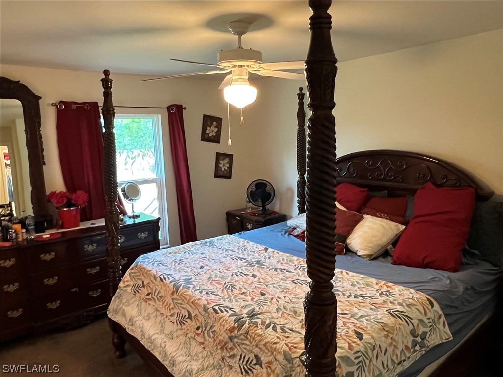 5018 Dolphin Circle LaBelle, FL 33935 - Photo 7 of 17 a bedroom with a bed window and dresser