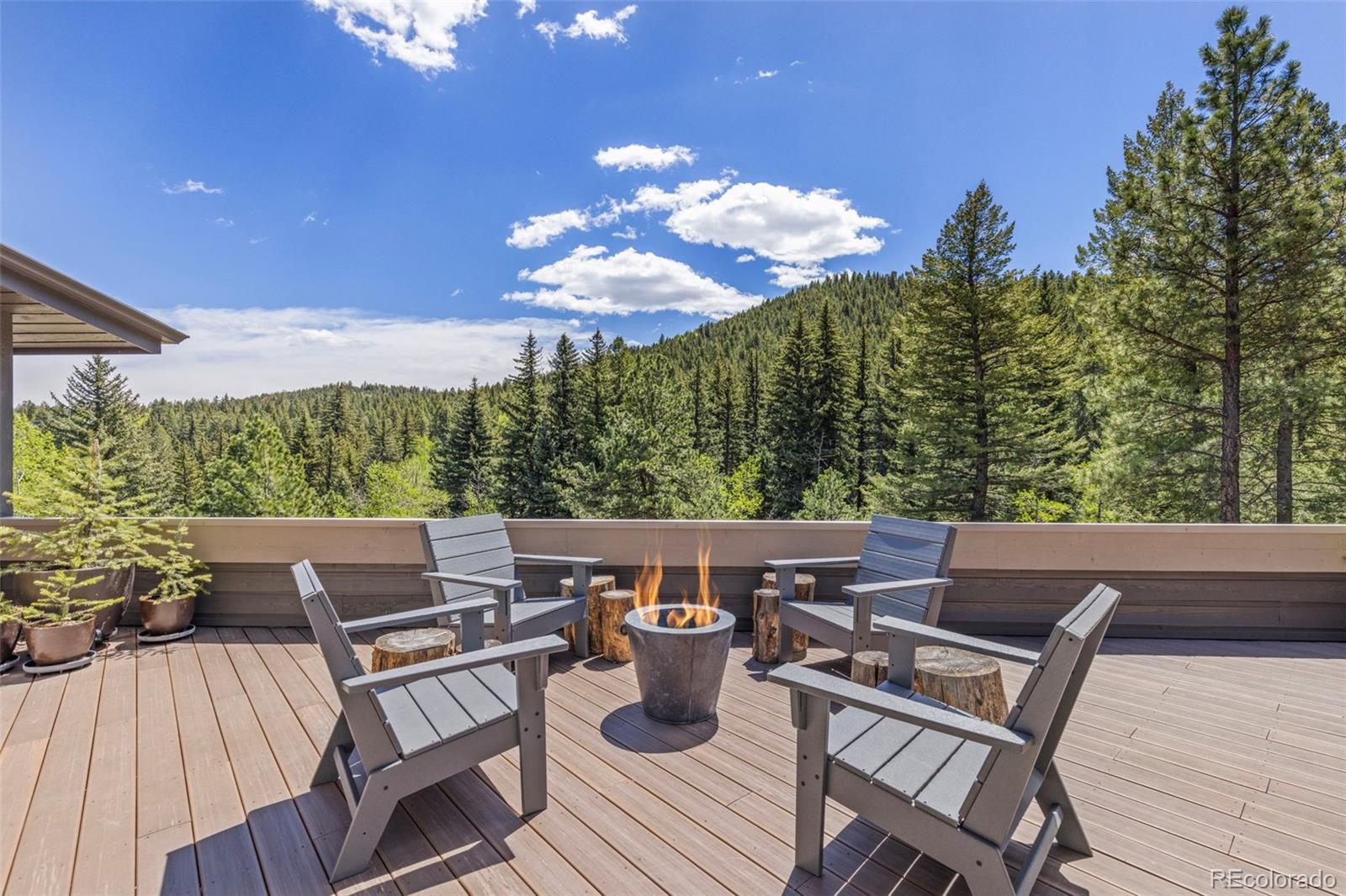 1323 South Snyder Gulch Road Evergreen, CO 80439 - Photo 8 of 47 a view of a chairs and table in patio of the house