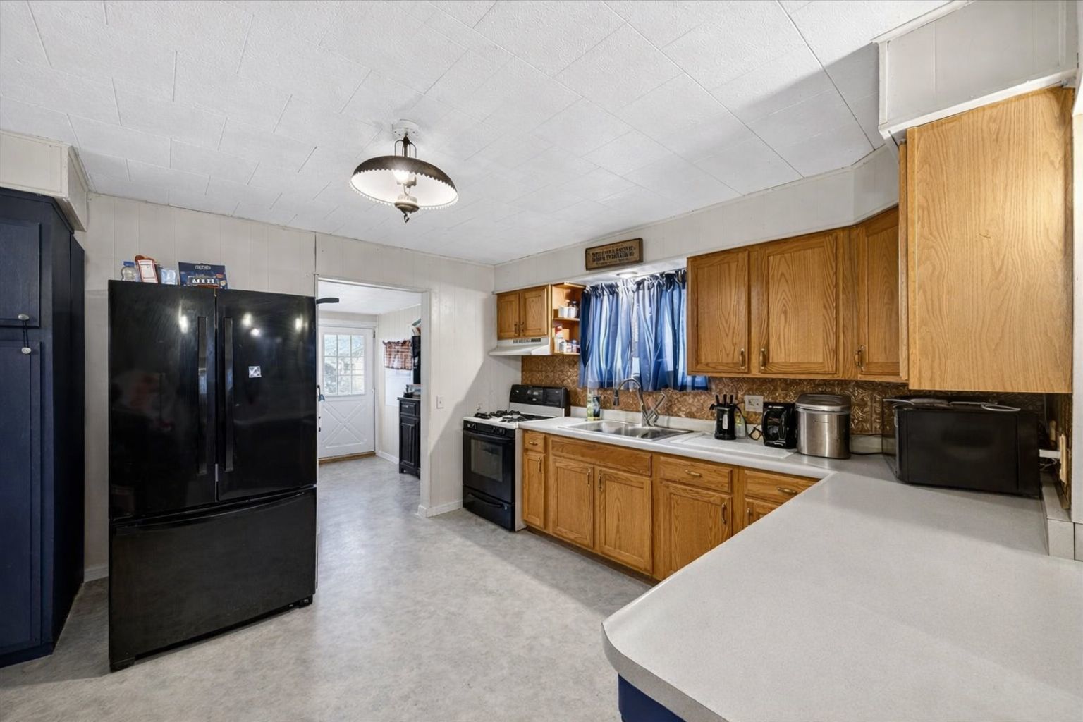 835 North 6th Avenue Canton, IL 61520 - Photo 2 of 14 a large kitchen with a large counter top stainless steel appliances and cabinets