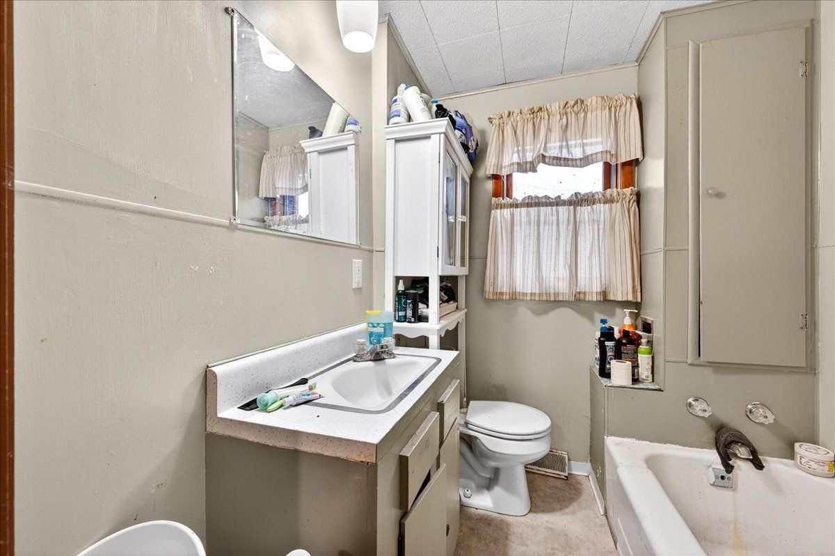 835 North 6th Avenue Canton, IL 61520 - Photo 10 of 14 a bathroom with a sink a toilet and shower