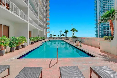 a building outdoor space with patio furniture and potted plants