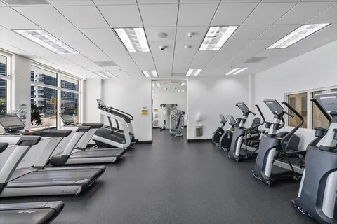 a living room with furniture a ceiling fan and a window