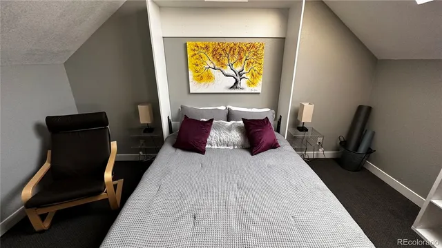 a bed room with a bed and a chair