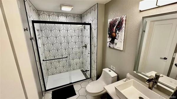 a bathroom with a toilet and a shower