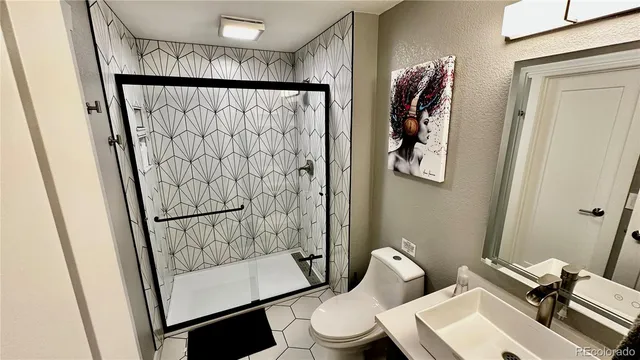 a bathroom with a toilet and a shower