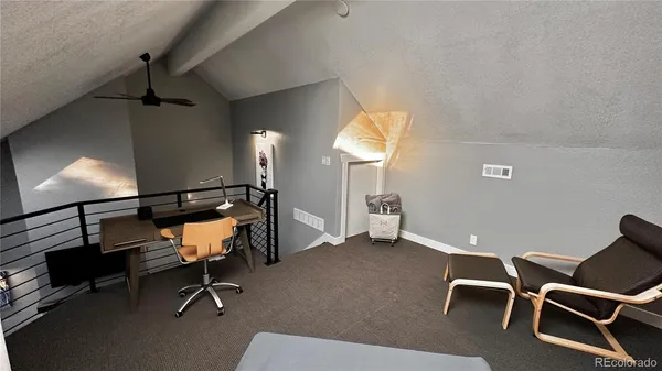 a room with table chairs and windows