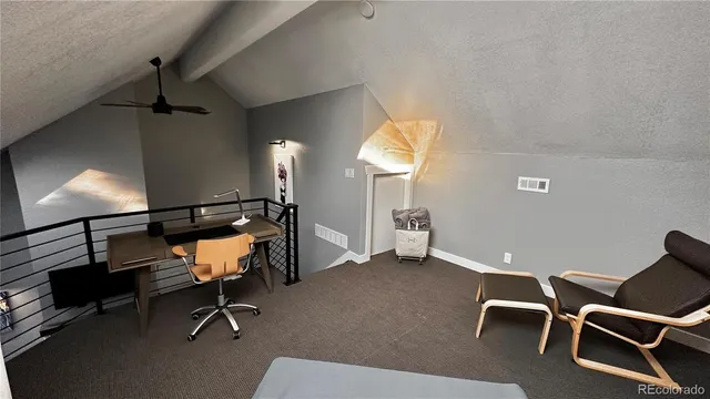 a room with table chairs and windows