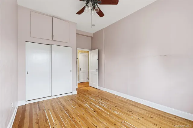 a view of an empty room with a ceiling fan