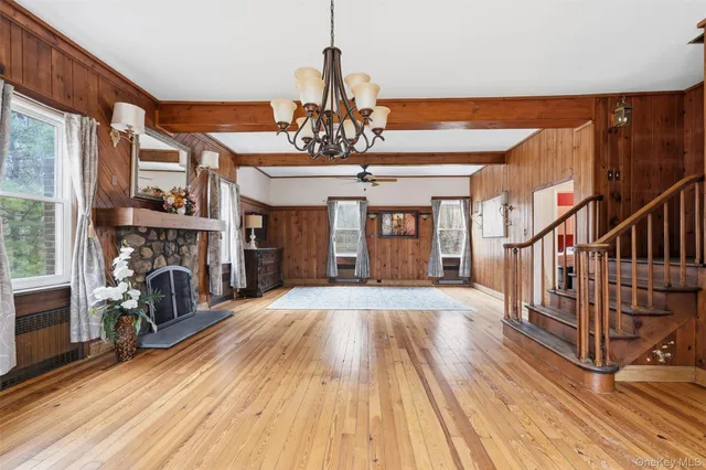a view of hall way with furniture and chandelier