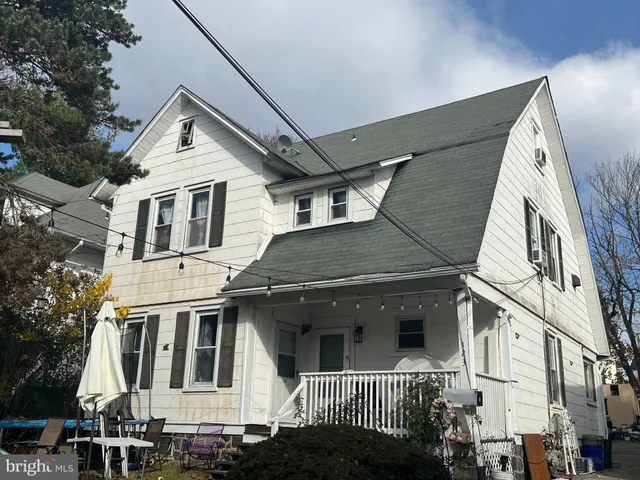 a view of a white house with large windows