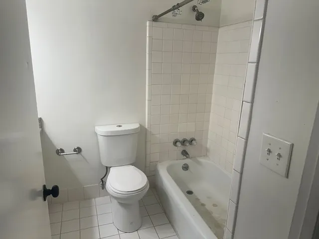a bathroom with a toilet and a shower