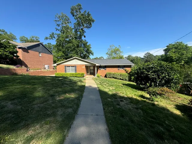 a front view of house with yard and green space