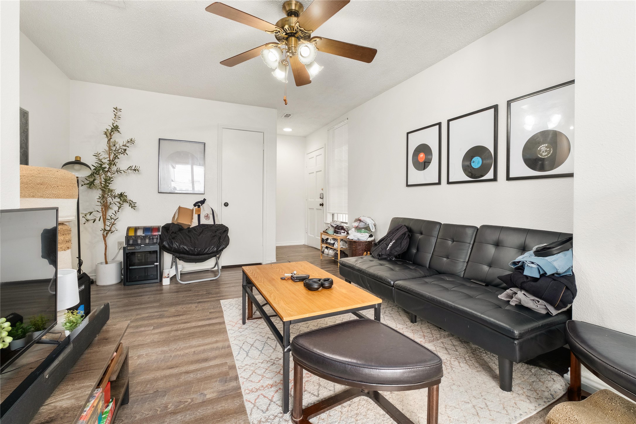 2409 Leon Street, Unit 307 Austin, TX 78705 - Photo 5 of 23 a living room with furniture and a flat screen tv